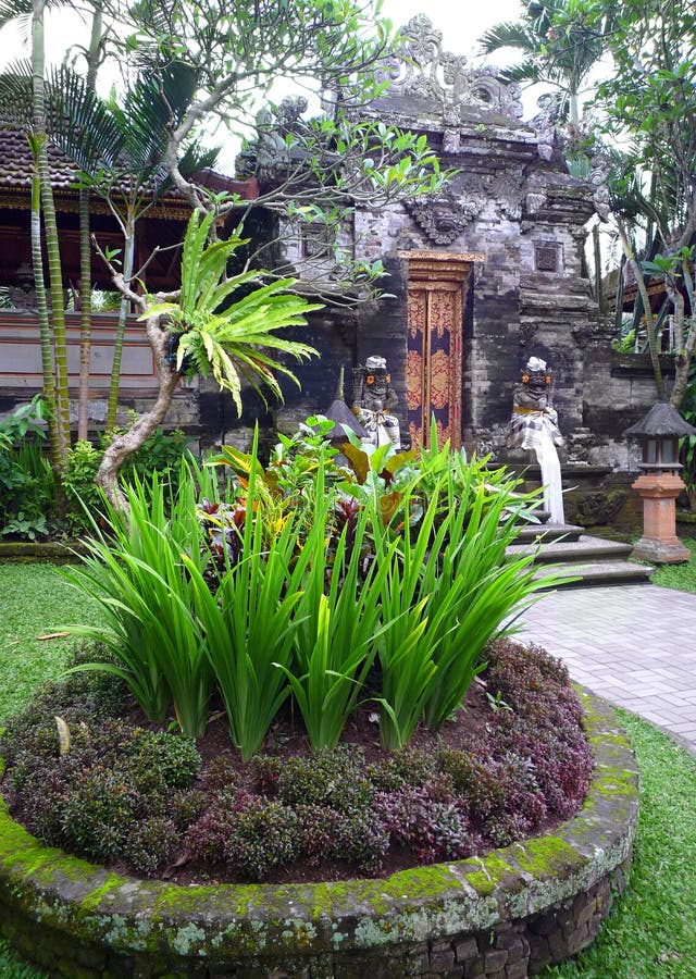 An image of a beautiful ancient palace architecture in Bali, Indonesia. Taken with the lush tropical landscaping in the gardens of the old palace grounds. Vertical color format. nobody in picture. Exotic asia travel photography, Bali tourism concept photo. An image of a beautiful ancient palace architecture in Bali, Indonesia. Taken with the lush tropical landscaping in the gardens of the old palace grounds. Vertical color format. nobody in picture. Exotic asia travel photography, Bali tourism concept photo.
