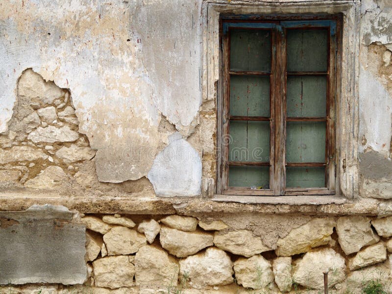 Old closed window on broken stone wall. Old closed window on broken stone wall