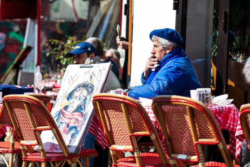 Старший художник при автопортрет сидя на кафе на известном Месте du Tertre в Montmartre стоковые фото Старший художник при автопортрет сидя на кафе на известном Месте du Tertre в Montmartre стоковые фото