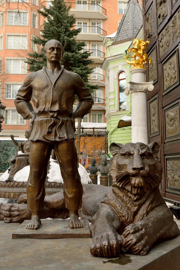 Moscow, Russia - March 22, 2018. Statue of Vladimir Putin in judo costume, with tiger at his feet, in the courtyard of Tsereteli museum in Moscow. Moscow, Russia - March 22, 2018. Statue of Vladimir Putin in judo costume, with tiger at his feet, in the courtyard of Tsereteli museum in Moscow.