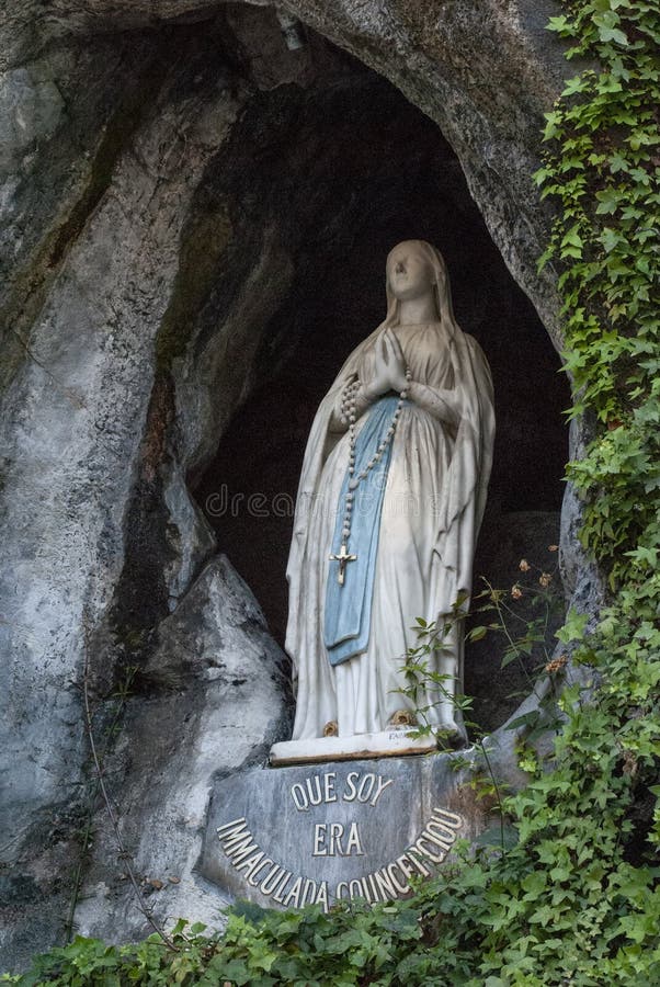 Lourdes, France; August 2013:The rock cave at Massabielle with the statue of the Virgin Mary where Saint Bernadette Soubirous claimed to have witnessed Marian apparitions from the Blessed Virgin Mary. Lourdes, France; August 2013:The rock cave at Massabielle with the statue of the Virgin Mary where Saint Bernadette Soubirous claimed to have witnessed Marian apparitions from the Blessed Virgin Mary.