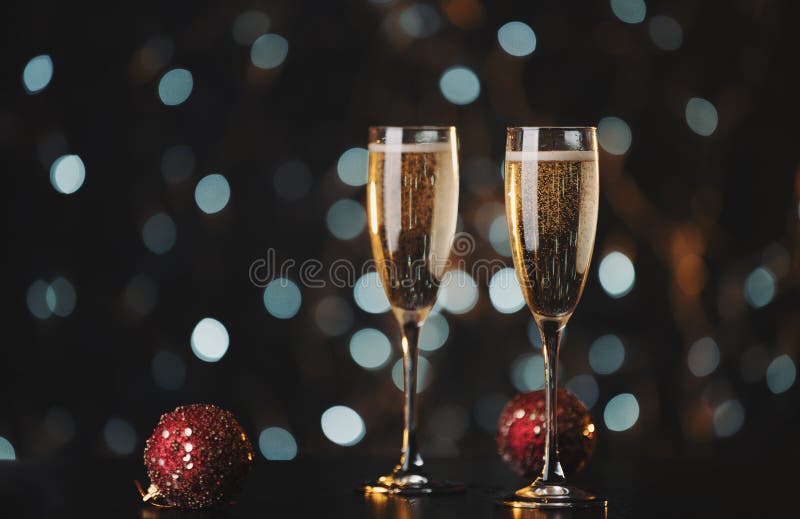 Holiday champagne glasses with New Year decorations. Holiday champagne glasses with New Year decorations