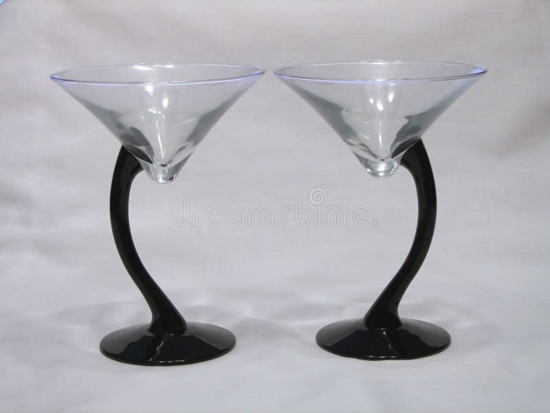 Two martini glasses side by side, turned opposite directions. Two martini glasses side by side, turned opposite directions.