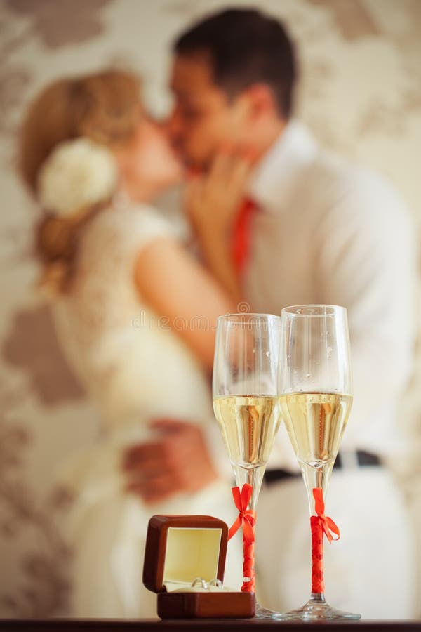 Wedding champagne glasses and kissing newly weds. Wedding champagne glasses and kissing newly weds