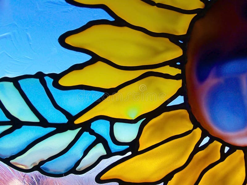 A speckled, textured stained glass sunflower window. A speckled, textured stained glass sunflower window.