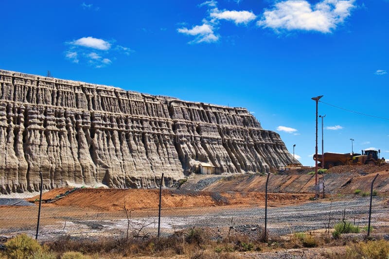 The walls of the huge tailings dump of the Central Norseman Gold Mine in Norseman,Western Australia,are eroded in amazing patterns. The walls of the huge tailings dump of the Central Norseman Gold Mine in Norseman,Western Australia,are eroded in amazing patterns