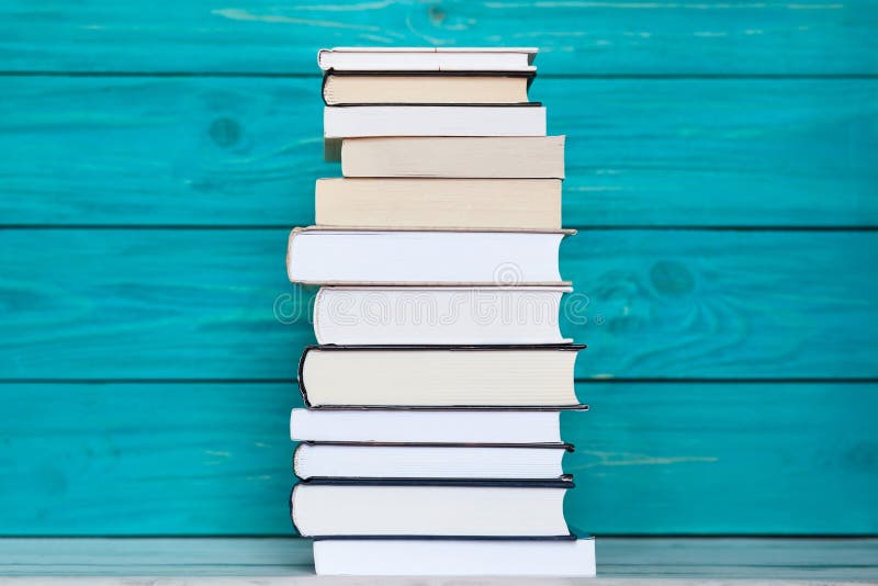 Стог книг на деревянной предпосылке бирюзы Concep образования стоковое фото Стог книг на деревянной предпосылке бирюзы Concep образования стоковое фото