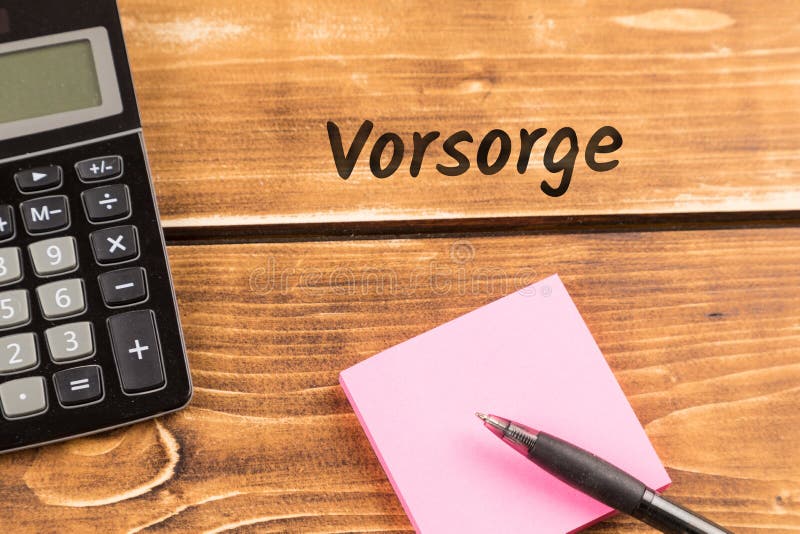 Стол дела с бумагой, ручкой и калькулятором с немецким vorsorge текста, в английском предохранении стоковая фотография Стол дела с бумагой, ручкой и калькулятором с немецким vorsorge текста, в английском предохранении стоковая фотография