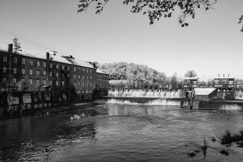 Prattville, Alabama, USA - December 9, 2017: Historic Pratt Cotton Gin Company and spillway in downtown Prattville after a rare snow storm. Prattville, Alabama, USA - December 9, 2017: Historic Pratt Cotton Gin Company and spillway in downtown Prattville after a rare snow storm.