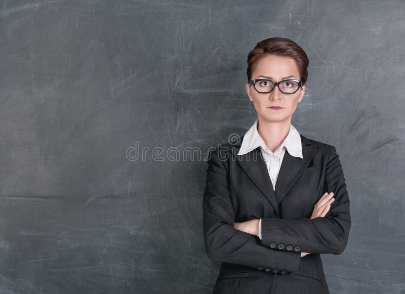 Strict teacher on the school blackboard background. Strict teacher on the school blackboard background