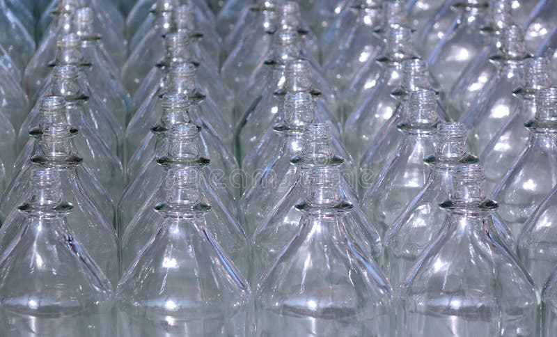 Rows of empty glass bottles with no caps. Rows of empty glass bottles with no caps