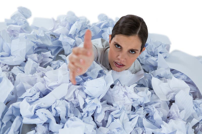 Conceptual image of woman in heap of crumple paper asking for help against white background. Conceptual image of woman in heap of crumple paper asking for help against white background
