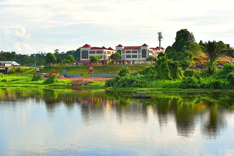 Сценарный взгляд реки Batu Kawa в Kuching, Сараваке смотря на современные здания и китайские кладбища стоковое фото Сценарный взгляд реки Batu Kawa в Kuching, Сараваке смотря на современные здания и китайские кладбища стоковое фото