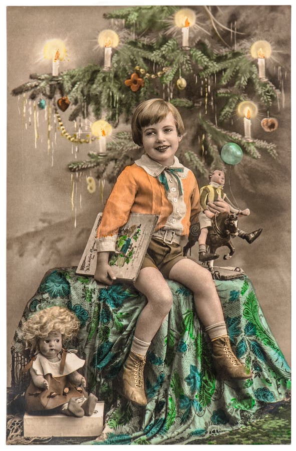 Happy boy with christmas tree, gifts and vintage toys. Antique picture with original film grain and scratches. Happy boy with christmas tree, gifts and vintage toys. Antique picture with original film grain and scratches