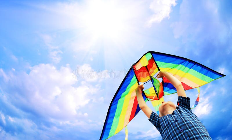 Happy little boy flies a kite in the sunny sky. Happy little boy flies a kite in the sunny sky