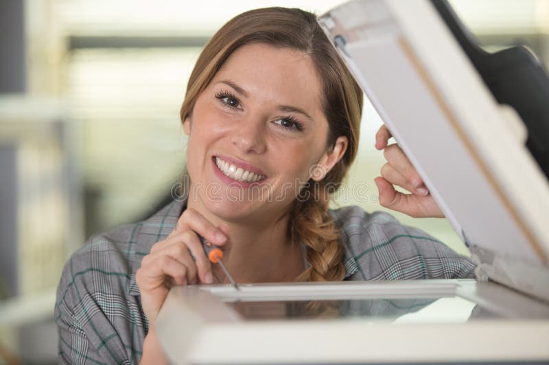 happy woman putting set of ink into plotter in printer. happy woman putting set of ink into plotter in printer