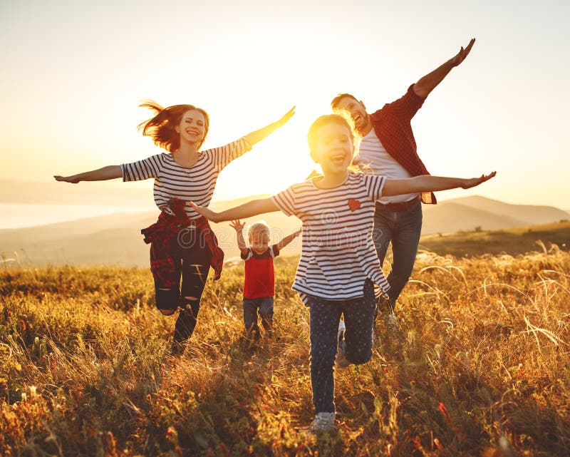 Happy family: mother, father, children son and  daughter on nature  on sunset. Happy family: mother, father, children son and  daughter on nature  on sunset