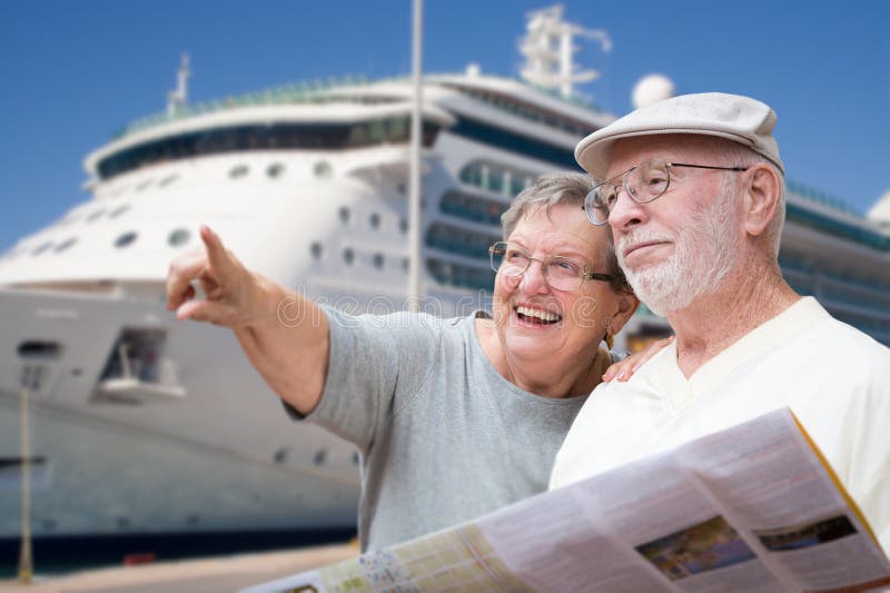 Happy Senior Adult Couple Tourists with Brochure Next To Passenger Cruise Ship. Happy Senior Adult Couple Tourists with Brochure Next To Passenger Cruise Ship.