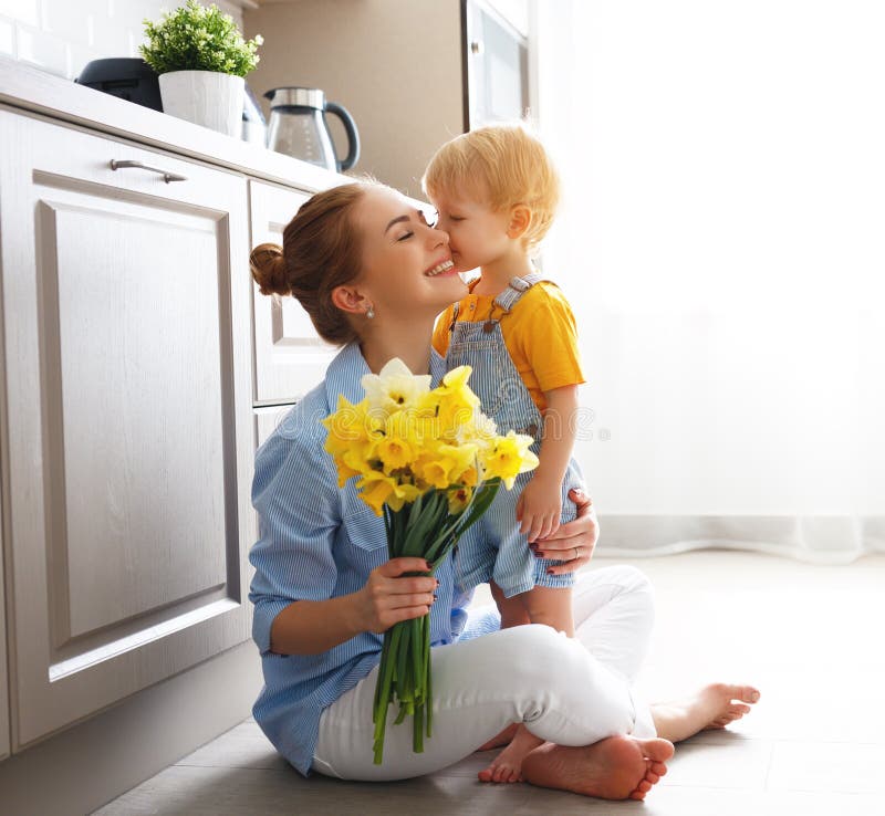 Happy mother`s day! baby son congratulates mother on holiday and gives flowers. Happy mother`s day! baby son congratulates mother on holiday and gives flowers