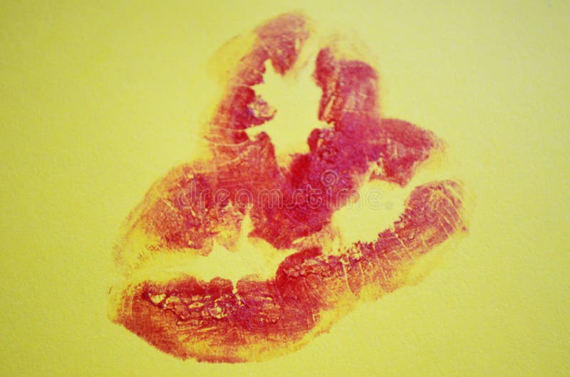 Lips with lipstick mark. Lipstick kiss on yellow background. Lips with lipstick mark. Lipstick kiss on yellow background