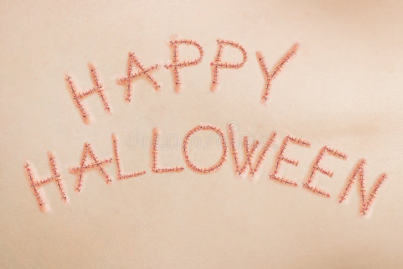 Happy Halloween sign, written in stitches on human skin, horror concept. Happy Halloween sign, written in stitches on human skin, horror concept