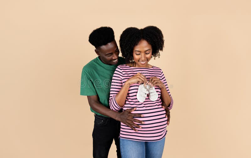 Loving happy couple, pregnant woman with her husband, black and white, looking at each other Loving happy couple, pregnant woman with her husband, black and white, looking at each other