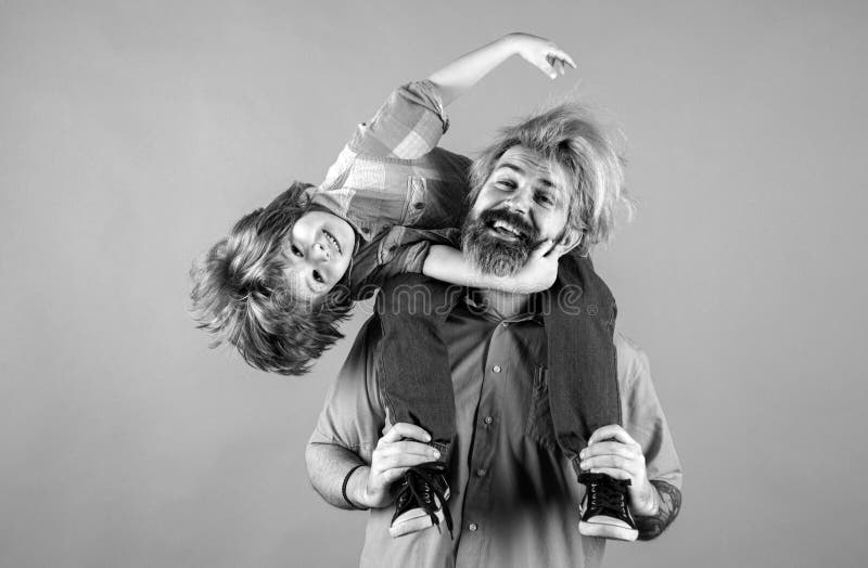 счастливый. портрет счастливого отца, который на своих плечах катает сына. симпатичный мальчик с папой в студии. стоковые изображения rf