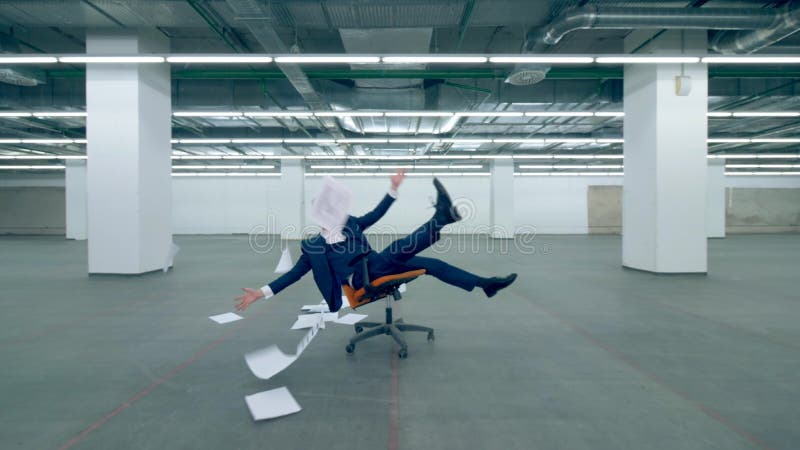 Счастливый работник офиса бросает бумагу в воздухе пока сидящ в стуле