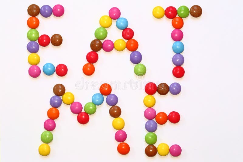 Colorful Chocolate Smarties precisely laid out to spell EAT ME. Colorful Chocolate Smarties precisely laid out to spell EAT ME.