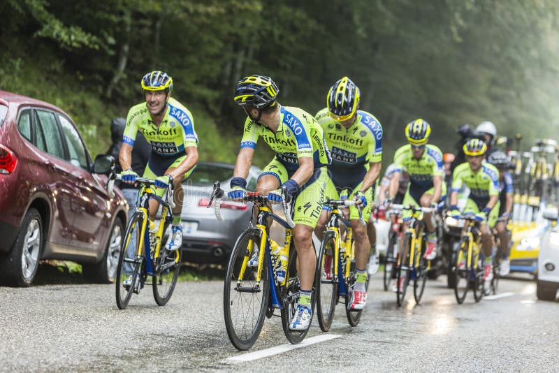 Col du Platzerwasel, France - July 14, 2014: Members of the Team Thinkoff - Saxo help Alberto Contador to climb the road to mountain pass Platzerwasel in Vosges mountains, during the stage 10 of Le Tour de France 2014. Inside this group Contador rides with a left tibial fracture after falling few kilometers before. He abandoned the race before reaching the summit of this climb. Paulinho and Tosatt. Col du Platzerwasel, France - July 14, 2014: Members of the Team Thinkoff - Saxo help Alberto Contador to climb the road to mountain pass Platzerwasel in Vosges mountains, during the stage 10 of Le Tour de France 2014. Inside this group Contador rides with a left tibial fracture after falling few kilometers before. He abandoned the race before reaching the summit of this climb. Paulinho and Tosatt