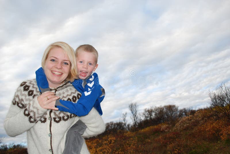 Mother and son having fun out in the nature. Photo taken in thingvellir, Iceland. Mother and son having fun out in the nature. Photo taken in thingvellir, Iceland.