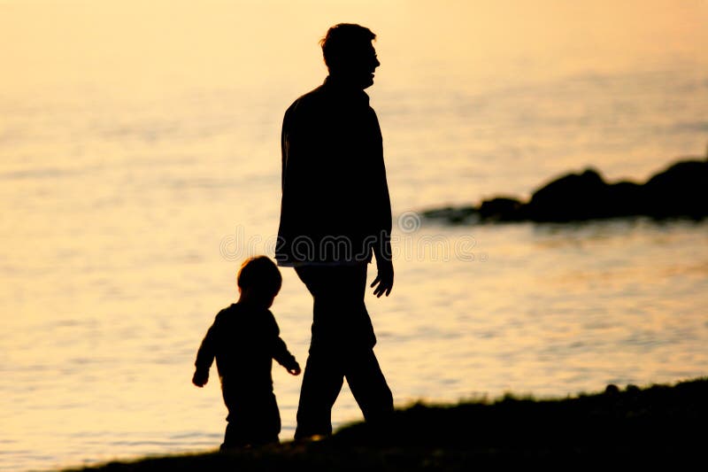 Father and Son walking by the sea. Father and Son walking by the sea