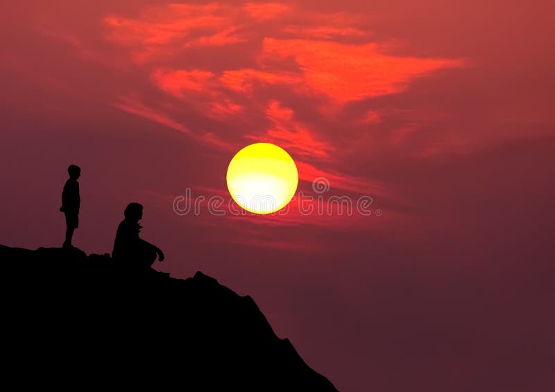 Silhouette of mother and son on mountain watching red and yellow setting sun. Silhouette of mother and son on mountain watching red and yellow setting sun