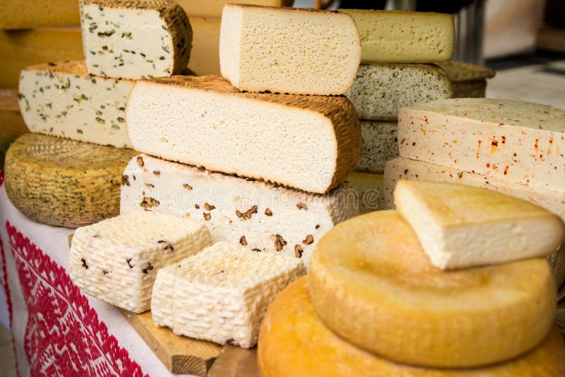 Handmade local cheese assortment, on a fair of traditional products, in Miercurea-Ciuc, Harghita, Romania. Shallow depth of field. Handmade local cheese assortment, on a fair of traditional products, in Miercurea-Ciuc, Harghita, Romania. Shallow depth of field.