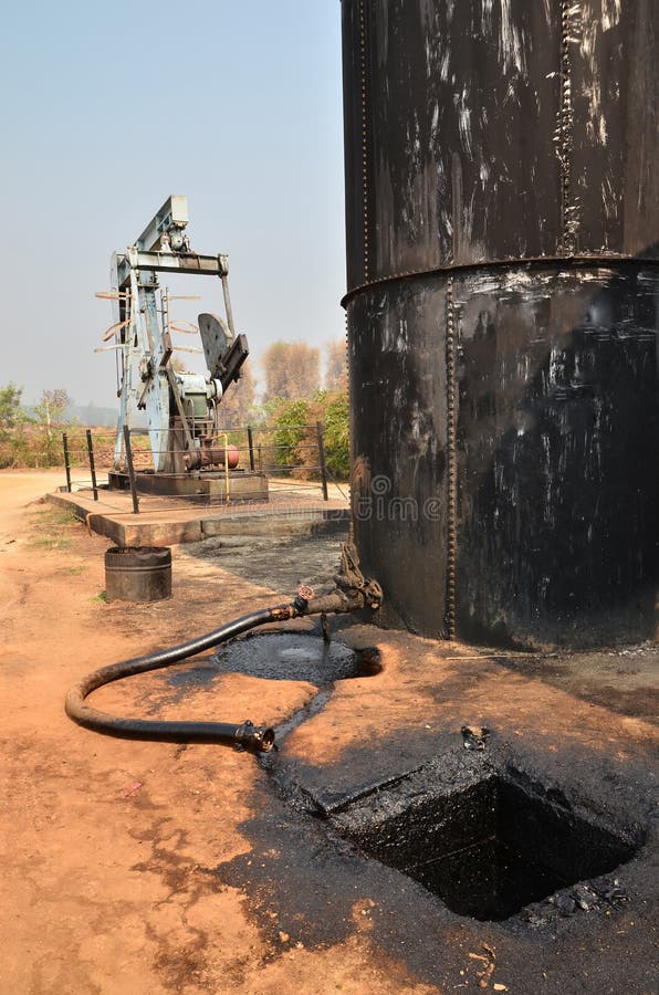 Сырая нефть Pumpjack нагнетая от нефтяной скважины стоковое изображение Сырая нефть Pumpjack нагнетая от нефтяной скважины стоковое изображение