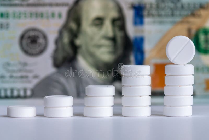 Pills stack and money for rising drug prices concept. Pills stack and money for rising drug prices concept