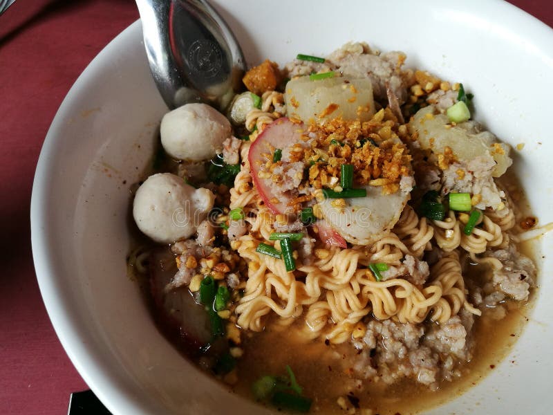 Thai street food : instant noodle with fish balls, red porks in spicy soup. Thai street food : instant noodle with fish balls, red porks in spicy soup