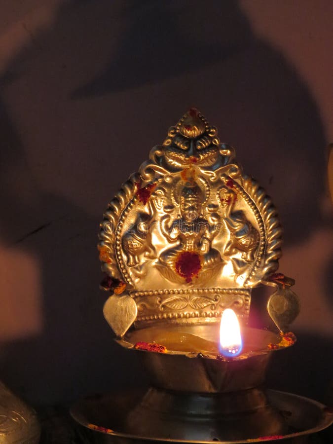 Tamil Nadu Traditional Silver Candle lightened in pooja room. Tamil Nadu Traditional Silver Candle lightened in pooja room