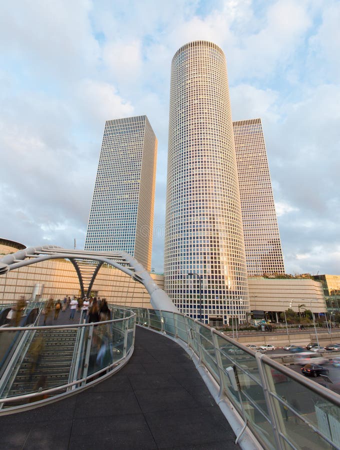 TEL AVIV, ISRAEL - MARCH 2, 2015: The skyscrapers of Azrieli Center in evening light by Moore Yaski Sivan Architects with measuring 187 m (614 ft) in height. TEL AVIV, ISRAEL - MARCH 2, 2015: The skyscrapers of Azrieli Center in evening light by Moore Yaski Sivan Architects with measuring 187 m (614 ft) in height.