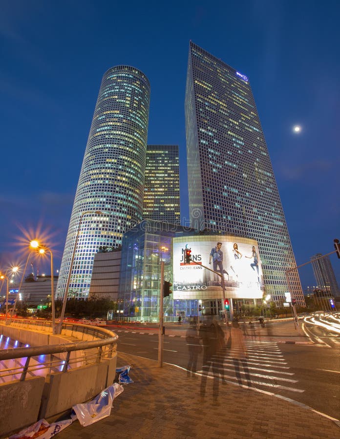 TEL AVIV, ISRAEL - MARCH 2, 2015: The skyscrapers of Azrieli Center in evening dusk by Moore Yaski Sivan Architects with measuring 187 m (614 ft) in height. TEL AVIV, ISRAEL - MARCH 2, 2015: The skyscrapers of Azrieli Center in evening dusk by Moore Yaski Sivan Architects with measuring 187 m (614 ft) in height.