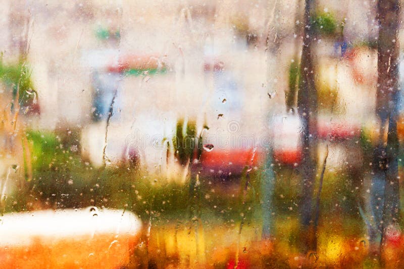 Abstract textured background of rainy window facing a blurred landscape (blur, texture effect). Abstract textured background of rainy window facing a blurred landscape (blur, texture effect)