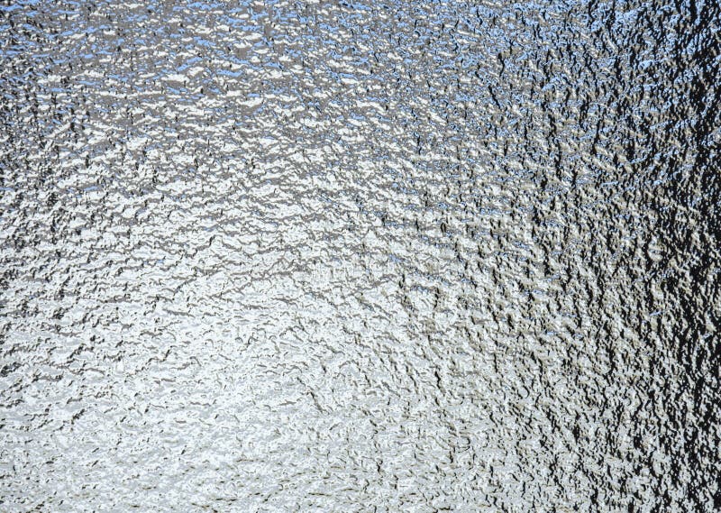 Textured Glass surface on a window or door with light coming through. Textured Glass surface on a window or door with light coming through.