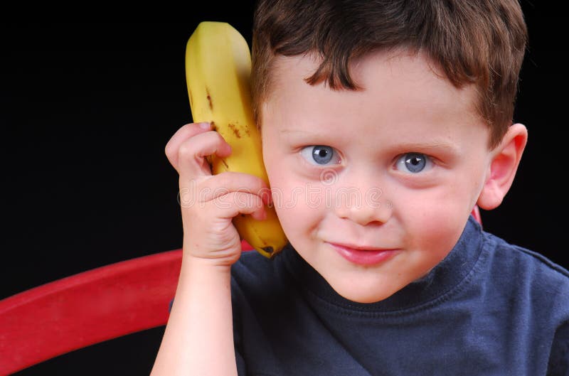 Young boy acting silly with banana phone. Young boy acting silly with banana phone