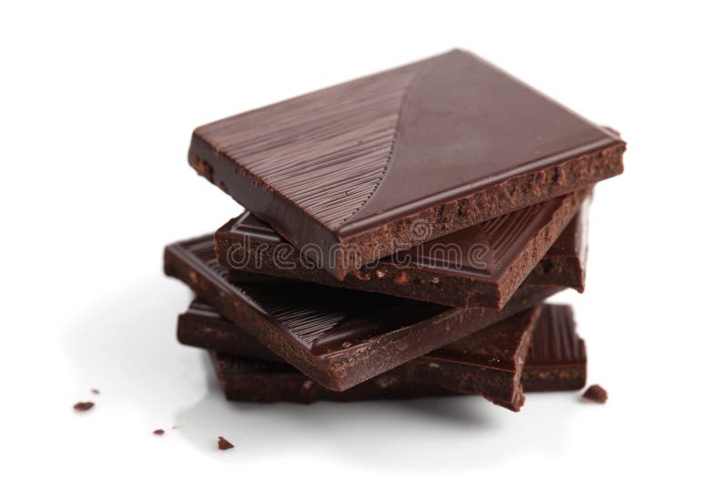 Stack of dark chocolate pieces on white background. Shallow dof. Stack of dark chocolate pieces on white background. Shallow dof