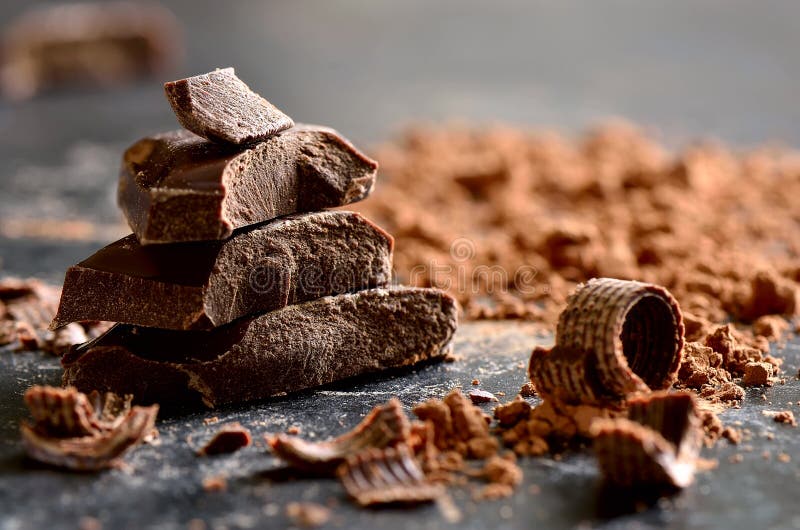 Dark chocolate stack, chips and powder. Dark chocolate stack, chips and powder