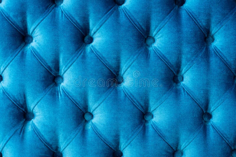 Coach-type velours screed tightened with buttons. Blue chesterfield style quilted upholstery backdrop close up. Capitone pattern texture background. Coach-type velours screed tightened with buttons. Blue chesterfield style quilted upholstery backdrop close up. Capitone pattern texture background