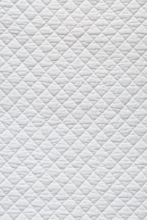 Closeup of white quilted fabric. Closeup of white quilted fabric.