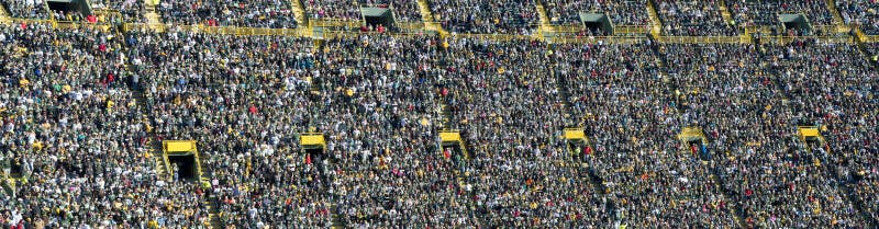 Banner, panoramic, or panorama style image of a sports stadium of a crowd of fans and people watching a game. Banner, panoramic, or panorama style image of a sports stadium of a crowd of fans and people watching a game.