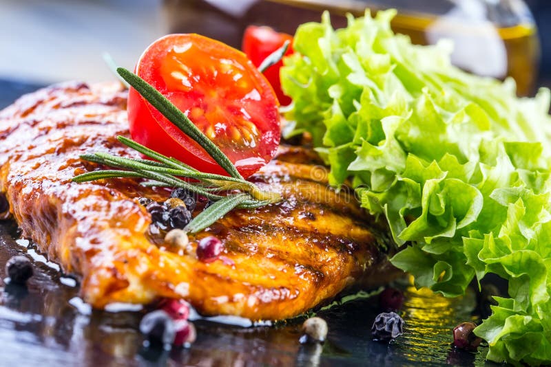 Steak chicken breast olive oil cherry tomatoes pepper and rosemary herbs. Steak chicken breast on granit board. Steak chicken breast olive oil cherry tomatoes pepper and rosemary herbs. Steak chicken breast on granit board.