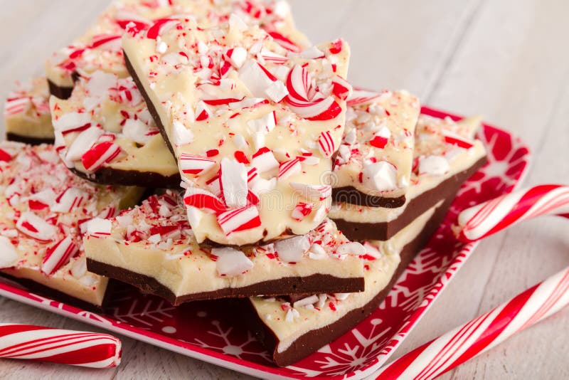 Red snowflake plate filled with chocolate peppermint bark candy and candy canes. Red snowflake plate filled with chocolate peppermint bark candy and candy canes
